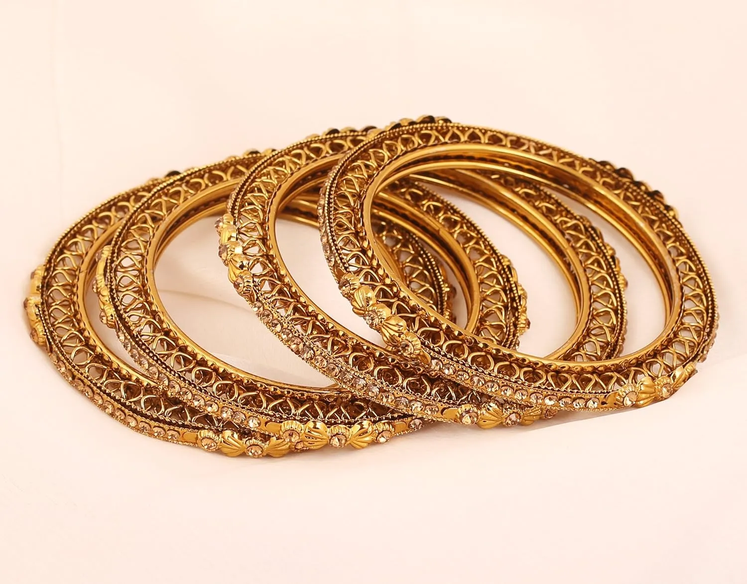 Touchstone "Golden Bangle Collection Ethnic Style Filigree Work Rhinestone Indian Bollywood Designer Jewelry Metal Bangle Bracelets in Antique Gold Tone for Women. Set of 4.